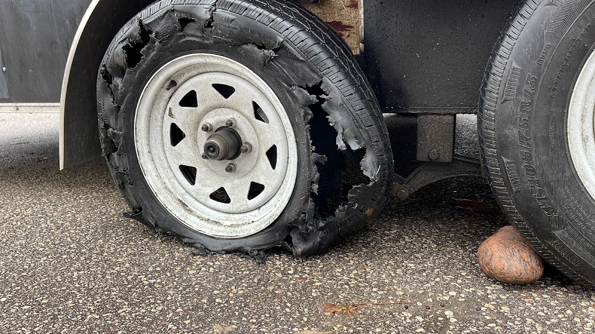 Damaged flat tire before mobile repair