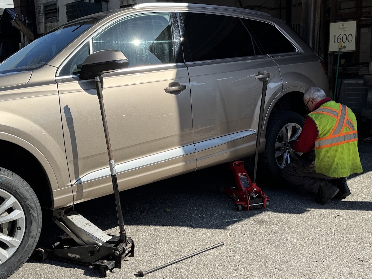 Technician working on an SUV tire with mobile equipment